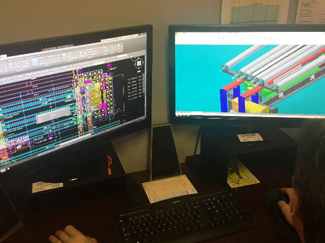 someone engineering a conveyor system on a computer